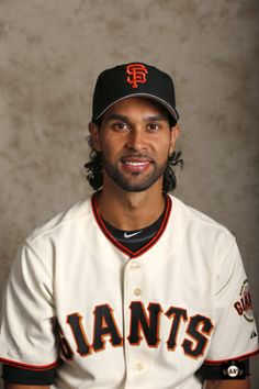 a professional baseball player poses for a photo