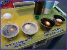 there are three cups on the table with eggs in them and two drinks to drink