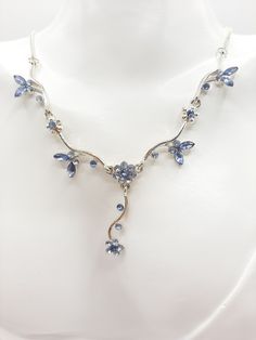 A cute blue crystal butterfly and flower silver necklace. The necklace shows some lovely blue crystal butterflies surrounding flowers on a silver tone metal necklace. This is just such a delicate looking piece of jewellery  but stunning when worn as any movement makes the blue crystal wings of the butterflies shimmer and shine and almost come to life. The necklace is in near EXCELLENT condition however, this is a preloved item and all is good but the back lobster clasp has a bit of tarnish on on Elegant Blue Sterling Silver Butterfly Necklace, Crystal Butterflies, Crystal Wings, Crystal Butterfly, Shimmer And Shine, Hippie Necklace, Metal Necklace, Shimmer N Shine, Metal Necklaces