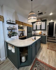 a large kitchen with an island in the middle and lots of shelves on the wall