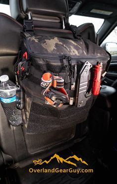 the back seat of a car with various items in it and an open water bottle