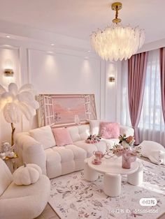 a living room filled with white furniture and pink curtains