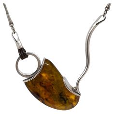 Handmade modernist sterling silver necklace with a large natural Baltic amber. Stamped 925 and includes the maker mark E & M. The amber measures 7cm long x 4.5 cm wide x 1.2 cm thick, The necklace measures 18 inches long, plus the pendant. Preowned, late 20th century and in good condition. The Maker, Late 20th Century, Baltic Amber, Sterling Silver Necklace, Makers Mark, Sterling Silver Necklaces, 20th Century, Jewelry Necklace Pendant, Amber