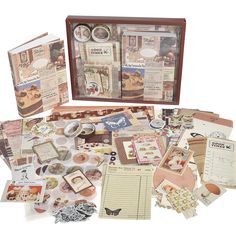 an assortment of papers and stickers in a wooden box