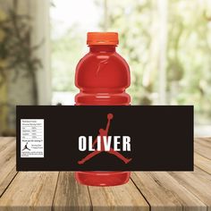 a red water bottle sitting on top of a wooden table