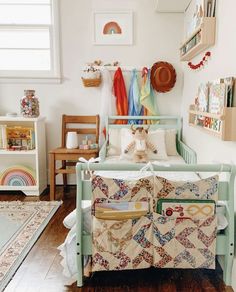 a child's room with a crib and toys on the wall, rugs and other items