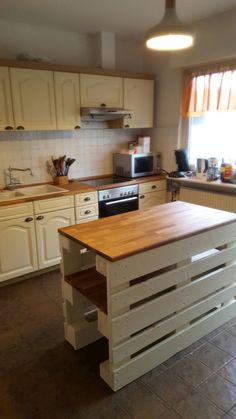 a kitchen with an island made out of pallets