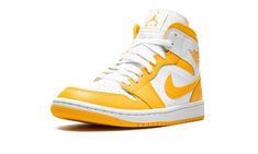 a pair of yellow and white sneakers