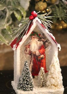 an ornament with a santa clause holding a sleigh