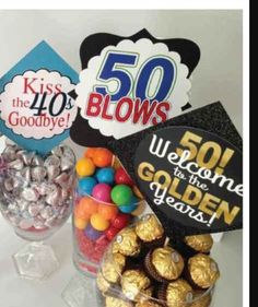 a table topped with lots of candy and candies next to a sign that says 50 blows