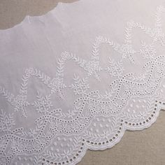 an image of white lace with flowers on the bottom and green label for ebay