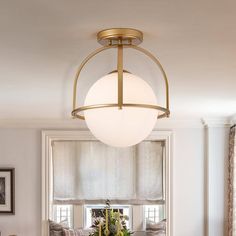 a dining room table and chairs with a light hanging over it in front of a window