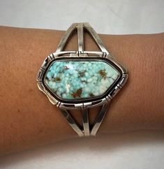 Absolutely stunning Navajo handmade sterling silver cuff bracelet has a large oval shaped spiderweb turquoise stone from the Dry Creek Mine. The cuff has 3 bands that come together at the ends, and has an intricate file design in the silver surrounding the stone. The stone is a beautiful light blue color spiderweb turquoise stone with white and brown matrix. Condition: Excellent! No damage, and only very minor wear consistent with age and handling. Artist: Signed Gilbert Nelson Stamped: Sterling Handmade Southwestern Turquoise Cuff Bracelet, Adjustable Southwestern Turquoise Cuff Bracelet, Spiderweb Turquoise, Southwest Jewelry Navajo Silver Cuff Bracelets, Unique Turquoise Nickel-free Cuff Bracelet, Bohemian Turquoise Nickel-free Cuff Bracelet, Beading Inspiration, Metal Smithing, File Design