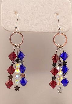 pair of red, white and blue earrings hanging from a hook on a hanger