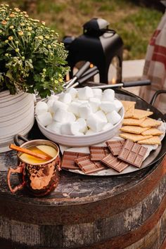 marshmallows and chocolate on a table outdoors