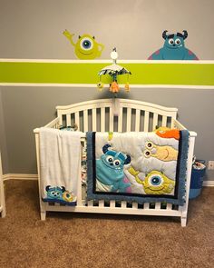 a baby crib with monsters on the wall