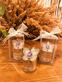 three jars with flowers in them sitting on a table