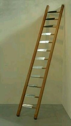 a wooden ladder leaning against a white wall