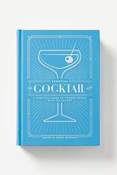 a blue book with the title cocktail an illustrated guide to modern drinkers, written in white lettering