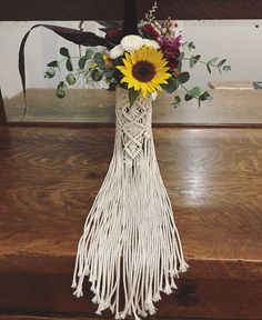 a vase filled with flowers on top of a wooden table