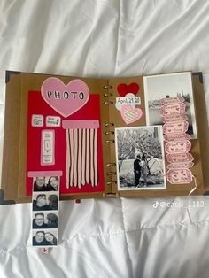 an open photo album with pictures and hearts