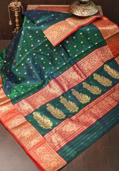 Chanderi sarees have always had a special place among the Royals and Bollywood for their sheer texture and sophistication. The recent patronage from the royal Scindia family has helped these mystical weaves gain popularity. It gets its name from its birthplace Chanderi, a small town in Madhya Pradesh. Due to the usage of high-quality yarns, the fabric has sheer texture and transparency and is often called 'woven air'. This saree comes in a pleasing tone with Chunri buttis woven in gold-ton. The Luxury Meenakari Pre-draped Saree In Dola Silk, Scindia Family, Sheer Texture, Chanderi Sarees, Chanderi Silk Saree, The Royals, Madhya Pradesh, Silk Organza, Peacock Blue