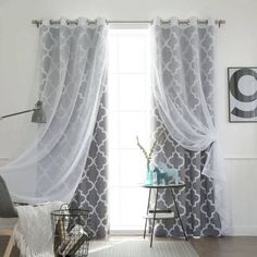 a living room filled with furniture and curtains