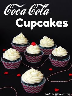 cupcakes with white frosting and red sprinkles on a black background