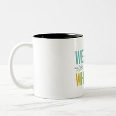 a white and black coffee mug with the words we are what we eat on it