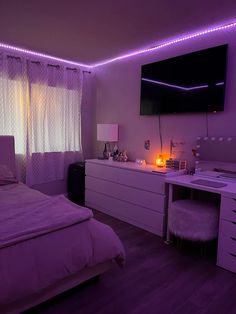 a bedroom with purple lighting and white furniture