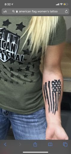 an american flag tattoo on the arm of a woman's left hand and wrist