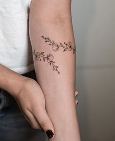 a woman with a tattoo on her arm is holding onto the arm of another person