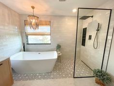 a white bath tub sitting next to a walk in shower