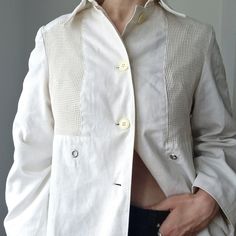 An original 1980s vintage white linen jacket by Spinney. A good retro jacket with utility-style detailing, great for mild weather. * Mesh front panels * Eyelet detail * Button front with cream buttons * Pointed collar * White linen * Shell: 50% cotton, 50% polyester * Fully lined in cream nylon lining * Hook for hanging SIZE * Bust: 40"  * Waist: 42"  * Hips: 46"  * Length: 27"  * Sleeve length: 15"  BRAND Spinney CONDITION Very good condition. Mild yellowing on the collar (cleaned), otherwise m Vintage Beige Utility Jacket For Spring, Vintage Single-breasted Utility Jacket For Spring, Vintage Single Breasted Utility Jacket For Spring, White Linen Outerwear With Pockets, White Retro Outerwear With Buttons, Retro White Outerwear With Buttons, White Button-up Utility Jacket For Spring, Vintage Beige Utility Jacket With Button Closure, White Linen Blazer With Button Closure