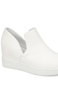 Add some freshness to your wardrobe with the Cardi sneaker by Journee Collection. This easy slip-on style shoe features a hidden wedge design with a round toe and platform bottom. The deep V side cut-outs add a unique touch and create an easy entry. Sizing: True to size. M=medium width. Round toe. Slip-on style. Split sides. Approx. 3" heel height. Approx. 3.5" shaft height, 11" opening circumference. ImportedThis item cannot be shipped to Canada. Comfortable White Slip-on Sneakers With Round Toe, White Slip-on Sneakers With Arch Support And Round Toe, White Slip-on Synthetic Wedge Sneakers, Casual Slip-on Synthetic Wedge Sneakers, Comfortable White Synthetic Slip-on Sneakers, Side Cuts, Journee Collection, Wedge Sneaker, Slip On Sneaker