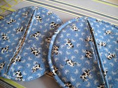 two pieces of blue fabric with black and white dogs on them, sitting next to each other