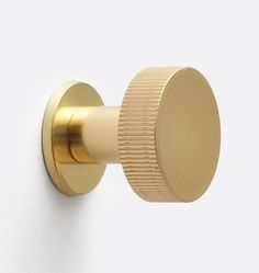 a close up of a door knob on a white wall with a gold colored handle