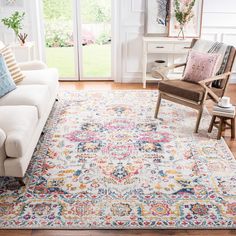 a living room with a couch, chair and rug