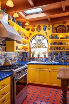 a kitchen with yellow cabinets and blue counter tops is decorated with colorful plates on the wall