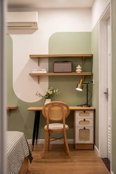 a chair and desk in a room with shelves on the wall above it, next to a bed