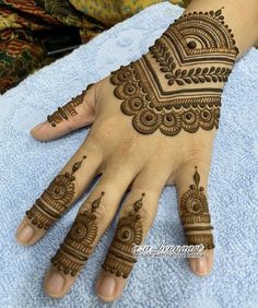 henna tattoo on the palm of someone's hand