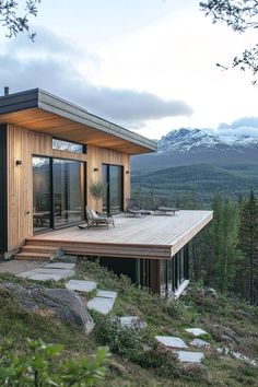 a small wooden house on top of a hill