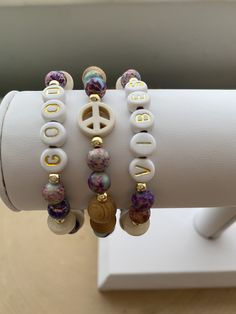 This is our GOOD VIBES stack! These are super stylish, comfortable and perfect for daily wear! A super cute boho-chic look! (These are meant to fit snug. If you would like them to feel loose and move around on your wrist, please size up). Each bracelet is carefully handmade with high quality materials: -6mm genuine purple galaxy sea sediment Jasper stones -4mm gold hematite beads -8mm natural wood beads -natural wood white pucalet spacers -white turquoise peace sign -7mm white acrylic letters -E Boho Peace Sign, Boho Bracelets Stack, Stack Bracelets, Purple Galaxy, Wood Bead Bracelet, Sister Jewelry, Word Bracelet, Acrylic Letters, Gold Bead Bracelets