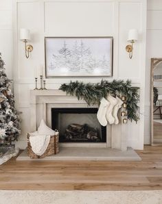 a living room decorated for christmas with stockings on the fireplace