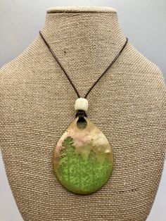 Hand stamped Green Polymer Clay with Blue/Gold Mica Powder to shine. Necklace length is 16 inches long. Pendant is 2 1/8 X 1 3/4 inches.  This necklace is fully hand made and hand finished so slight variations in color/finish should be expected. Mica Powder color will shine differently in different light. I also have a Pine Tree Forest Necklace.... https://www.etsy.com/listing/961272102/pine-tree-forest-necklace-polymer-clay?ref=shop_home_active_39&frs=1 Unique Adjustable Stamped Necklace, Bohemian Green Stamped Jewelry, Nature-inspired Green Necklace With Large Pendant, Green Stamped Jewelry As Gift, Green Stamped Jewelry For Gifts, Polymer Clay Tree, Clay Tree, Pine Tree Forest, Forest Necklace