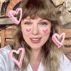 a woman with pink hearts painted on her face