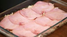 raw meat in a glass dish on a wooden table