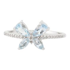 This is part of Chairish’s Fine Jewelry assortment.  Dainty Aquamarine Diamond Butterfly Ring in 18K Gold featuring natural aquamarine of 0.56 carats and diamonds of 0.06 carats. The gorgeous handcrafted ring goes with every style. Aquamarine is useful for moving through transition and change.  Designed with pear and marquise cut aquamarine set in center making a butterfly with diamonds set in center that makes it a perfect fit to wear it on your wedding or style it with any of your basic outfit Luxury Light Blue Aquamarine Rings, Light Blue Diamond Ring With Gemstone, Light Blue Diamond Rings With Gemstone, Light Blue Aquamarine Ring With Diamond Accents, Fine Jewelry Aquamarine Diamond Ring, Diamond Butterfly Ring With Gemstone For Formal Occasions, Formal Diamond Butterfly Ring With Gemstone, Light Blue Diamond Rings With Prong Setting, Light Blue Diamond Ring With Brilliant Cut