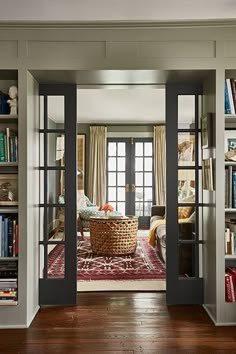 an instagramted photo of a living room with french doors and bookshelves