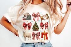 a woman wearing a t - shirt with christmas decorations on it and bows around her neck